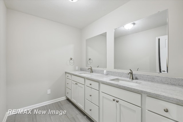60 Golfview Dr, Saginaw, MI 48638 - bathroom with double vanity and baseboards