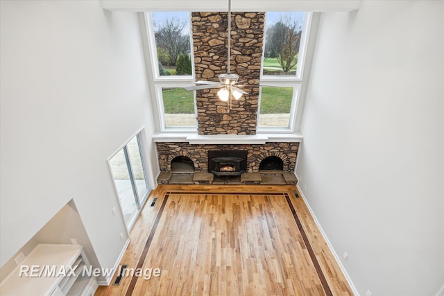 interior space with a wood stove and wood-type flooring