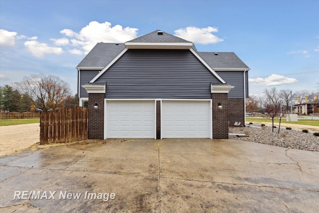 60 Golfview Dr, Saginaw, MI 48638 - view of side of property featuring brick siding, driveway, a garage, and roof with shingles