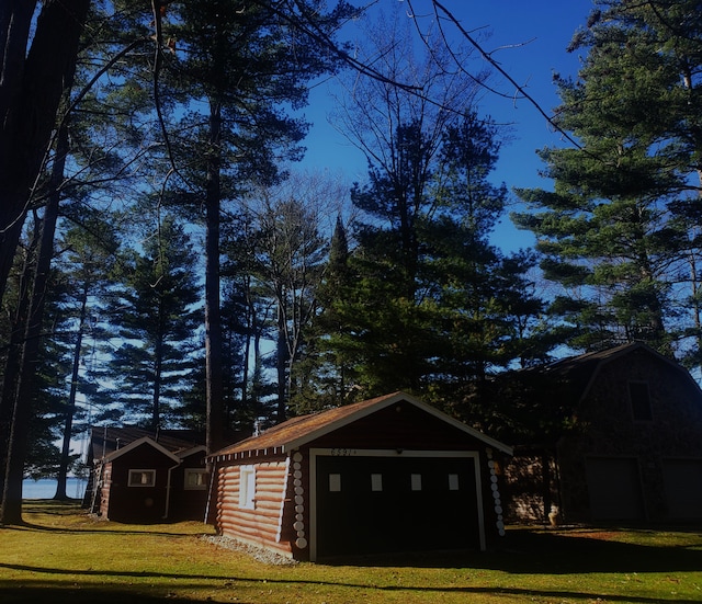 view of outbuilding featuring a yard and a garage