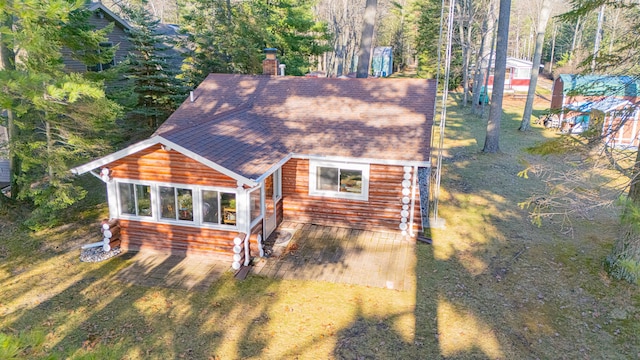 back of property with a patio area and a yard