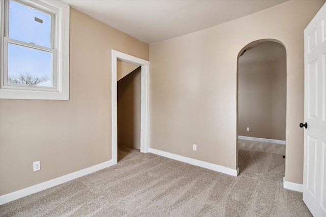 unfurnished room with light colored carpet