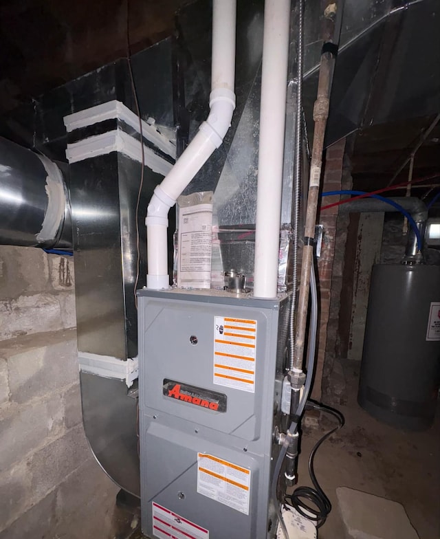 utility room featuring water heater