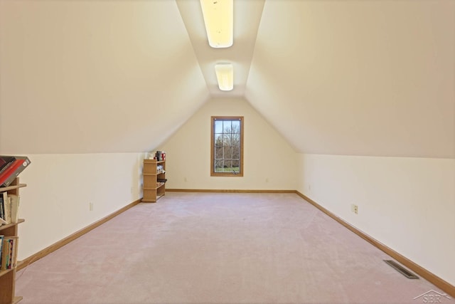 bonus room with light carpet and lofted ceiling