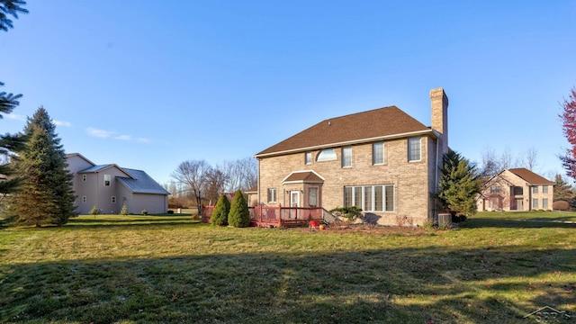 back of house featuring a deck and a yard