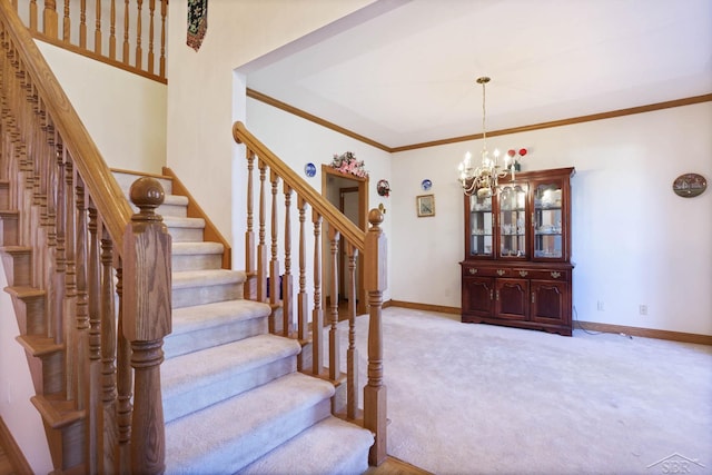 staircase with carpet floors, crown molding, and an inviting chandelier