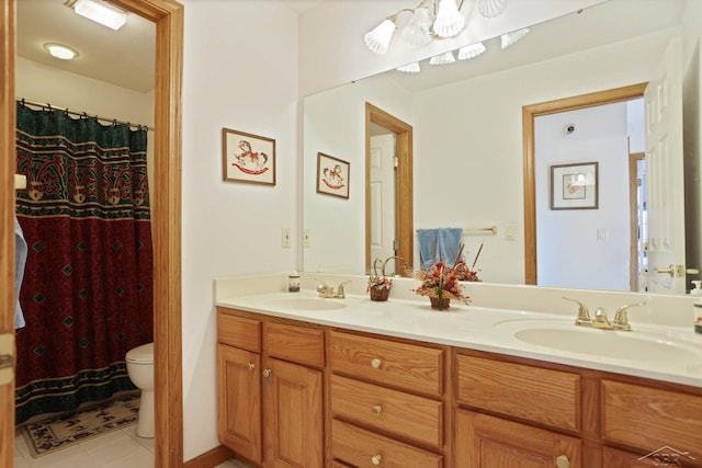 bathroom with tile patterned floors, vanity, and toilet