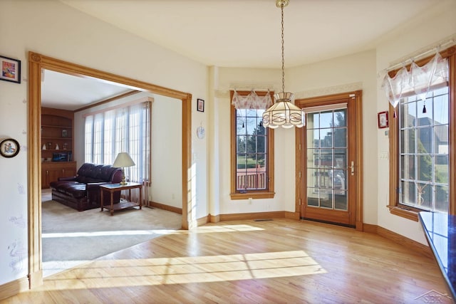 dining room with light hardwood / wood-style flooring and a notable chandelier