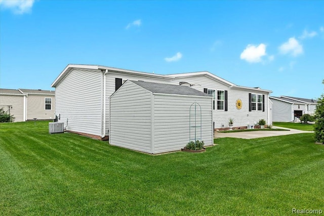 rear view of house featuring a yard, a patio, and central AC