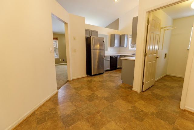 kitchen featuring gray cabinets, freestanding refrigerator, light countertops, dishwasher, and a wealth of natural light