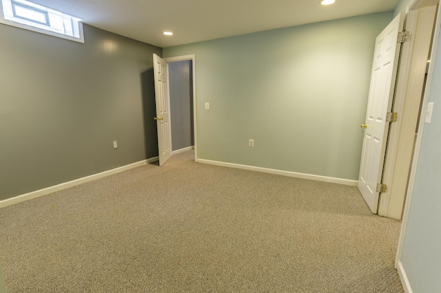 interior space with light carpet, recessed lighting, and baseboards