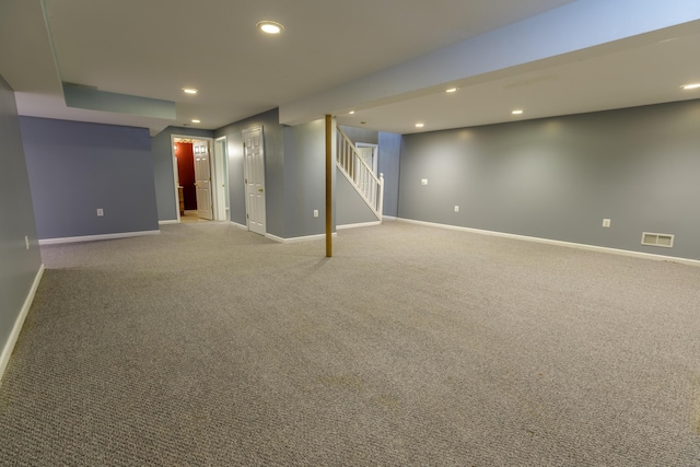 finished basement with visible vents, recessed lighting, stairway, and baseboards