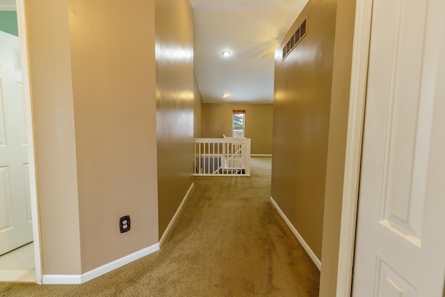 hall with visible vents, carpet flooring, an upstairs landing, and baseboards