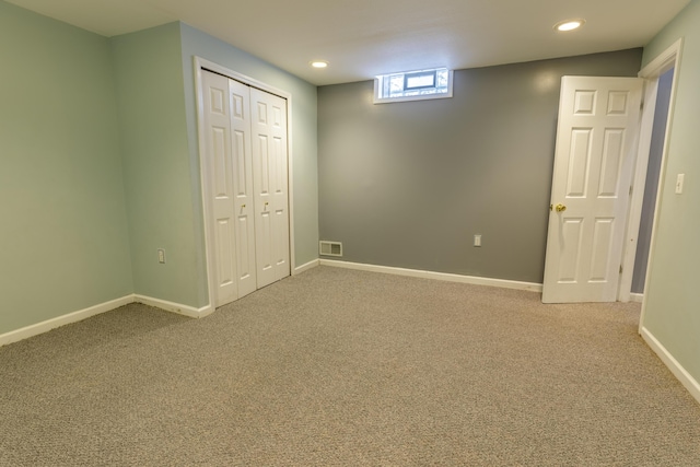 unfurnished bedroom featuring visible vents, baseboards, light colored carpet, recessed lighting, and a closet