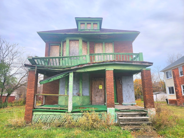 view of front facade featuring a balcony and a porch