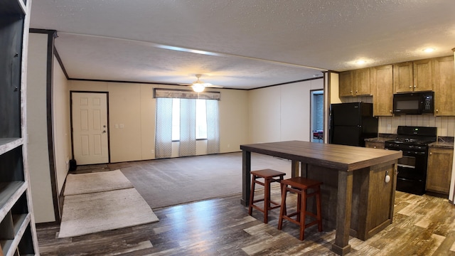 kitchen featuring ceiling fan, dark wood-type flooring, black appliances, and a textured ceiling