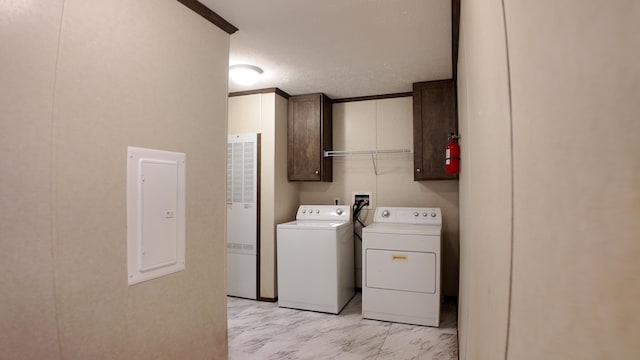 washroom featuring cabinets, independent washer and dryer, a textured ceiling, and electric panel