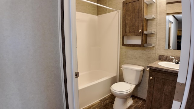 full bathroom featuring bathtub / shower combination, vanity, tile walls, hardwood / wood-style floors, and toilet