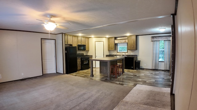 kitchen with a center island, dark hardwood / wood-style floors, a textured ceiling, a breakfast bar area, and black appliances