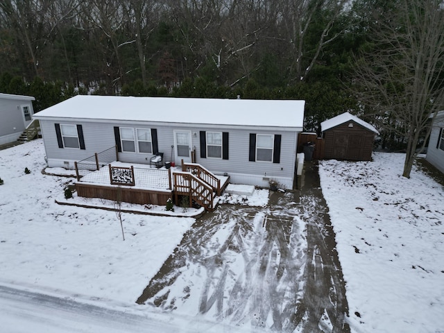 manufactured / mobile home with a storage unit and a wooden deck