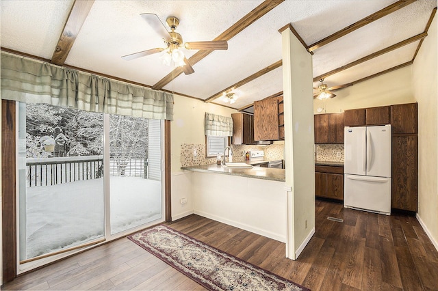 doorway to outside with lofted ceiling with beams, sink, and dark wood-type flooring