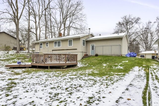 snow covered property with a lawn and a wooden deck