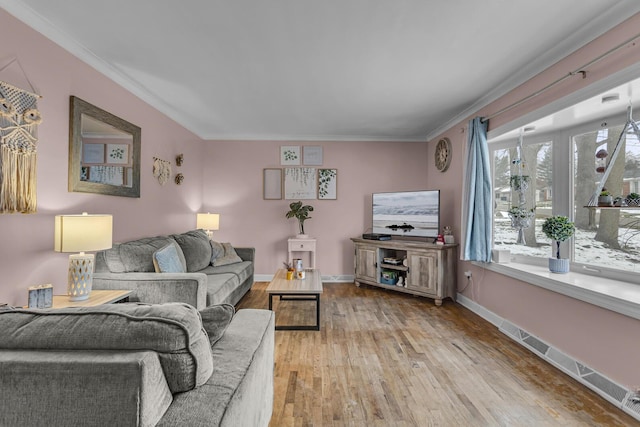 living room with wood-type flooring and ornamental molding