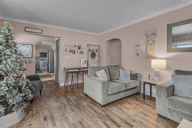 living room with wood-type flooring and crown molding