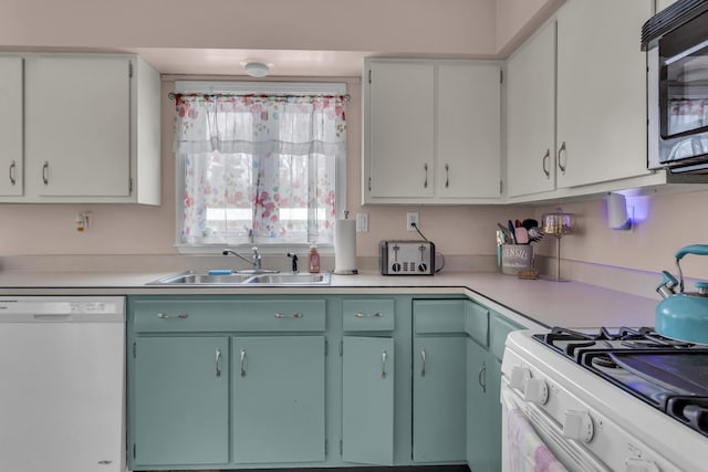 kitchen featuring white cabinetry, white appliances, and sink