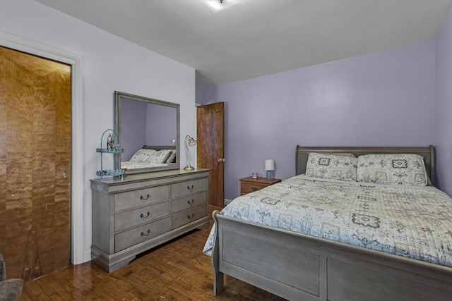 bedroom with dark hardwood / wood-style flooring