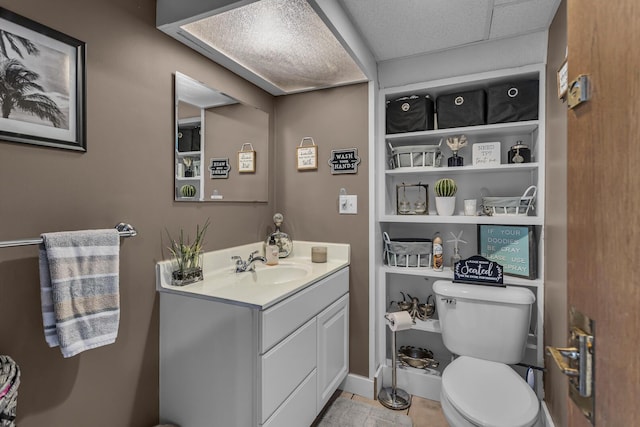 bathroom with tile patterned floors, vanity, and toilet