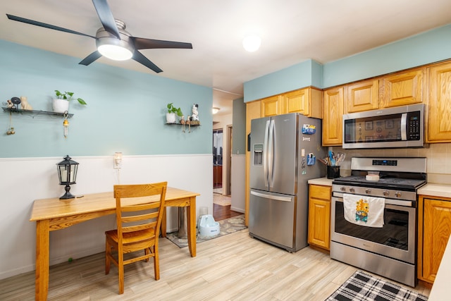 kitchen with backsplash, ceiling fan, stainless steel appliances, and light hardwood / wood-style flooring