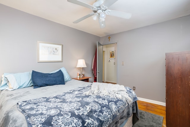 bedroom with ceiling fan and hardwood / wood-style floors