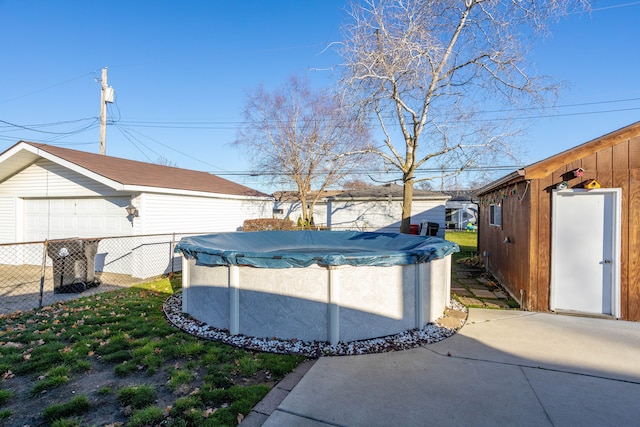 exterior space with an outbuilding and a covered pool