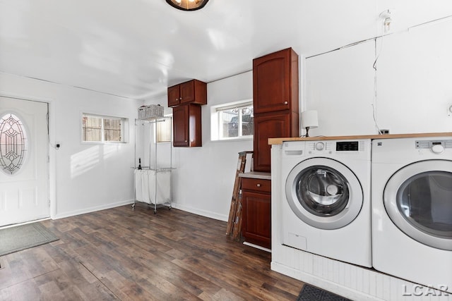 washroom with cabinets, dark hardwood / wood-style floors, and washer and clothes dryer