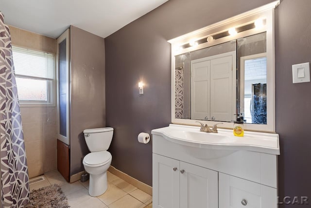 bathroom featuring tile patterned flooring, vanity, and toilet