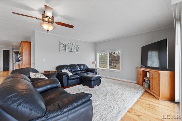 living room with ceiling fan, light hardwood / wood-style flooring, and crown molding