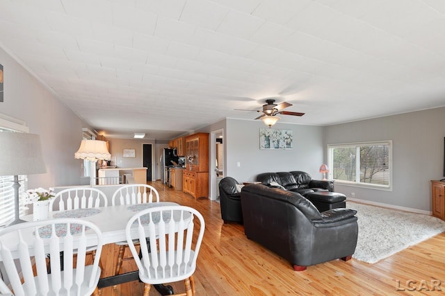 living room with ceiling fan and light hardwood / wood-style floors