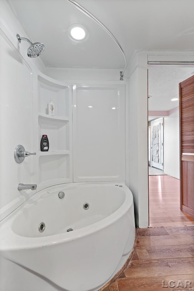 bathroom with shower / tub combination and hardwood / wood-style flooring