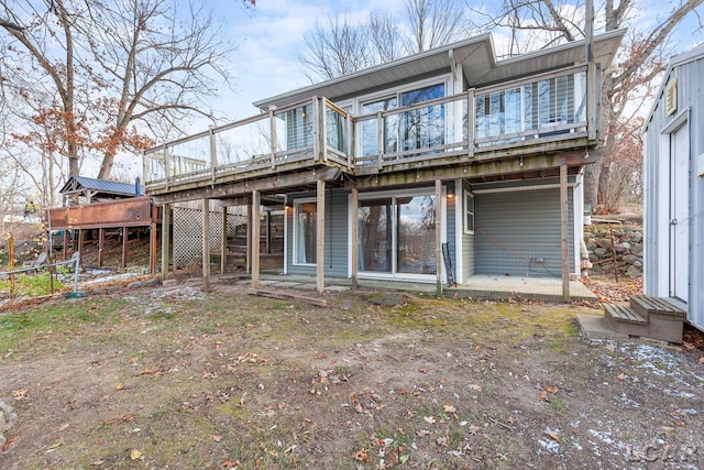 rear view of property with a wooden deck