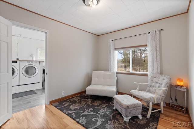 sitting room with washer and clothes dryer and wood-type flooring