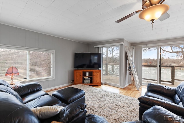 living room featuring light hardwood / wood-style floors, ceiling fan, and ornamental molding