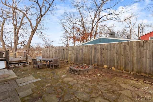 view of patio featuring a fire pit and a deck