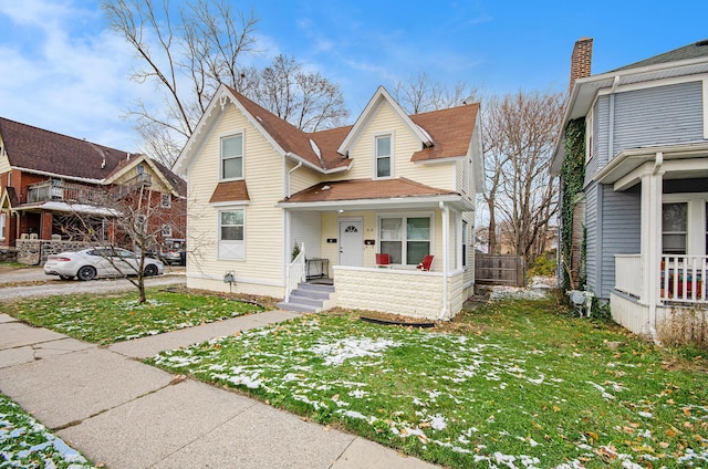 view of front property with covered porch and a front yard