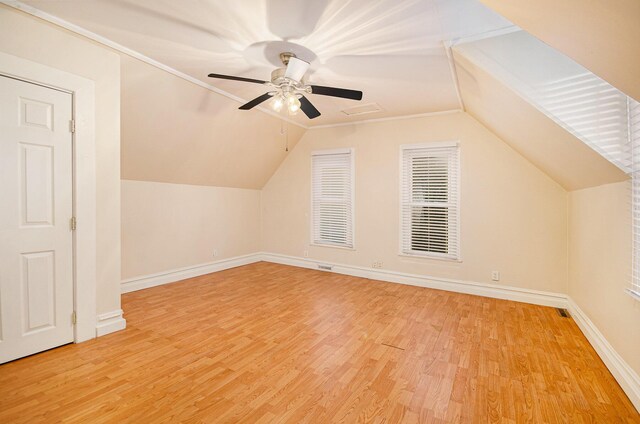 additional living space with ceiling fan, light hardwood / wood-style floors, and vaulted ceiling