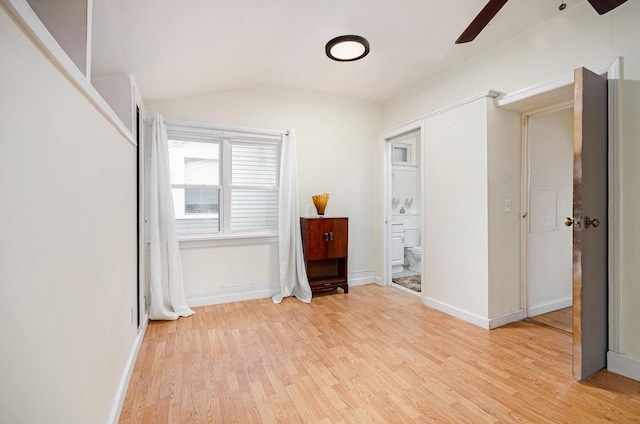 unfurnished bedroom with ceiling fan, light hardwood / wood-style floors, and lofted ceiling