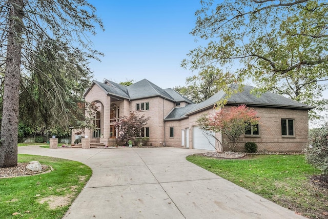 view of front of house with a front yard and a garage