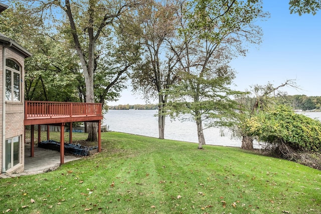 view of yard with a deck with water view
