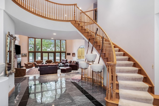 stairs featuring a high ceiling