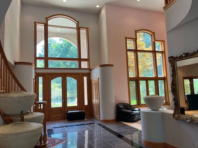 foyer with a high ceiling and french doors
